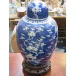 LARGE ORIENTAL BLUE AND WHITE PRUNUS PATTERN GINGER JAR WITH COVER ON TREEN SUPPORT (RESTORED),