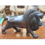 HEAVILY CARVED EBONISED LIGNUM VITAE LION,