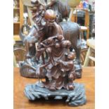 HEAVILY CARVED ORIENTAL FIGURE GROUP ON STAND,