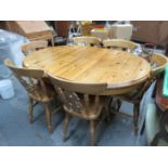 PINE CIRCULAR EXTENDING DINING TABLE AND SIX CHAIRS