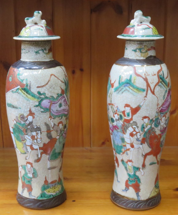 PAIR OF DECORATIVE POTTERY VASES WITH COVERS DECORATED WITH ORIENTAL SCENES,