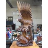 LARGE TREEN CARVING DEPICTING AN EAGLE AND EAGLETS,