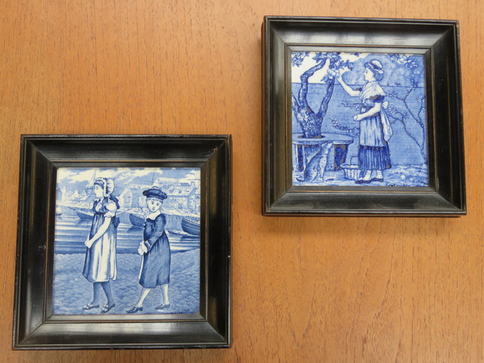 PAIR OF BLUE AND WHITE CERAMIC TILES, POSSIBLY BY WEDGWOOD, WITHIN EBONISED FRAMES,