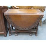 CARVED OAK DROP LEAF DINING TABLE