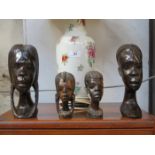 FOUR CARVED AFRICAN BUSTS