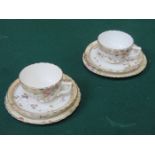 PAIR OF VICTORIAN STYLE FLORAL DECORATED AND GILDED CERAMIC TRIOS