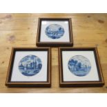 SET OF THREE FRAMED BLUE AND WHITE CERAMIC TILES