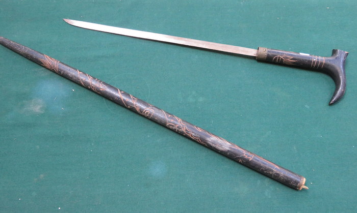 CARVED EBONISED AND BRASS MOUNTED SWORD STICK