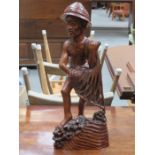 INDONESIAN CARVED FIGURE OF A FISHERMAN,