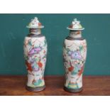 PAIR OF DECORATIVE POTTERY VASES WITH COVERS DECORATED WITH ORIENTAL SCENES,
