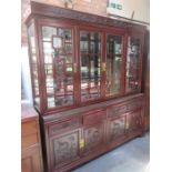 CARVED ORIENTAL FOUR DOOR GLAZED DISPLAY UNIT WITH FOUR DRAWERS AND FOUR CUPBOARD DOORS BELOW