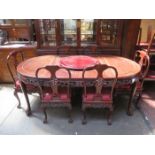 HEAVILY CARVED ORIENTAL EXTENDING DINING TABLE WITH PIERCEWORK DECORATION ON BALL AND CLAW SUPPORTS,