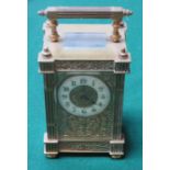 ORNATELY DECORATIVE BRASS AND GLASS CASED FRENCH STYLE CARRIAGE CLOCK