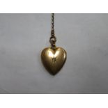 9ct GOLD HEART FORM LOCKET SET WITH SINGLE STONE ON GOLD COLOURED CHAIN