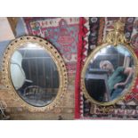 TWO GILDED OVAL WALL MIRRORS