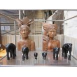 PAIR OF INDIAN STYLE CARVED TREEN BUSTS AND GRADUATED EBONISED ELEPHANTS