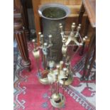 THREE BRASS FIRESIDE SET AND REPOUSSE DECORATED BRASS STICK STAND