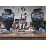PAINTED METAL MUSKETEER AND RELIEF DECORATED POTTERY VASES