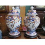 PAIR OF HANDPAINTED AND GILDED ORIENTAL STORAGE JARS WITH COVERS ON STANDS,