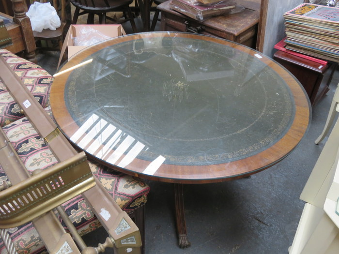 LEATHER TOPPED CIRCULAR COFFEE TABLE ON QUADRAFOIL SUPPORTS