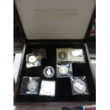 CASE CONTAINING EIGHT VARIOUS SILVER PROOF COINS ETC.