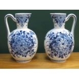 PAIR OF DELFT FLORAL DECORATED CERAMIC WATER JUGS,