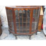 SINGLE DOOR MAHOGANY BOW FRONTED DISPLAY CABINET ON BALL AND CLAW SUPPORTS