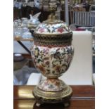 HIGHLY DECORATIVE ORIENTAL VICTORIAN GILDED CERAMIC AND GILT METAL STEMMED URN WITH COVER ON RAISED