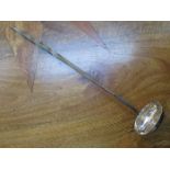 HALLMARKED SILVER COIN MOUNTED LADLE WITH TWIST HANDLE.