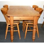 A heavy quality pine kitchen table and four chairs.