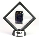 An unmounted emerald cut natural sapphire in a display case, sapphire, 4.4 x 3cm.