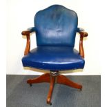 An upholstered vintage swivel desk chair.