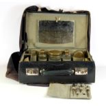 A vintage leather travel case and contents with a canvas fitted cover, 39 x 27 x 13cm.