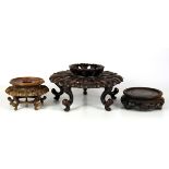 An attractive Chinese carved hardwood stand, Dia. 21cm, together with two further carved wood