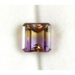 A 4.05ct natural ametrine, clarity VVS, in a glass display case.