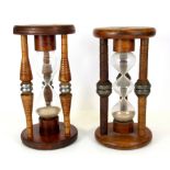 Two antique silk bobbins converted into egg timers, H. 25cm.