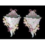 A pair of 19th Century French porcelain cherub wall pockets, H. 25cm.