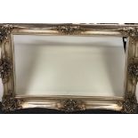 A superb large ornate silvered framed bevelled mirror, 185 x 124cm.