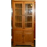 A leaded oak veneered corner cabinet, W. 82cm.