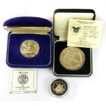 A silver commemorative Belize coins and a further coin.