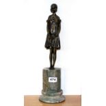 An Art Deco style figure of a girl on a tall green and grey marble base, H. 42cm.