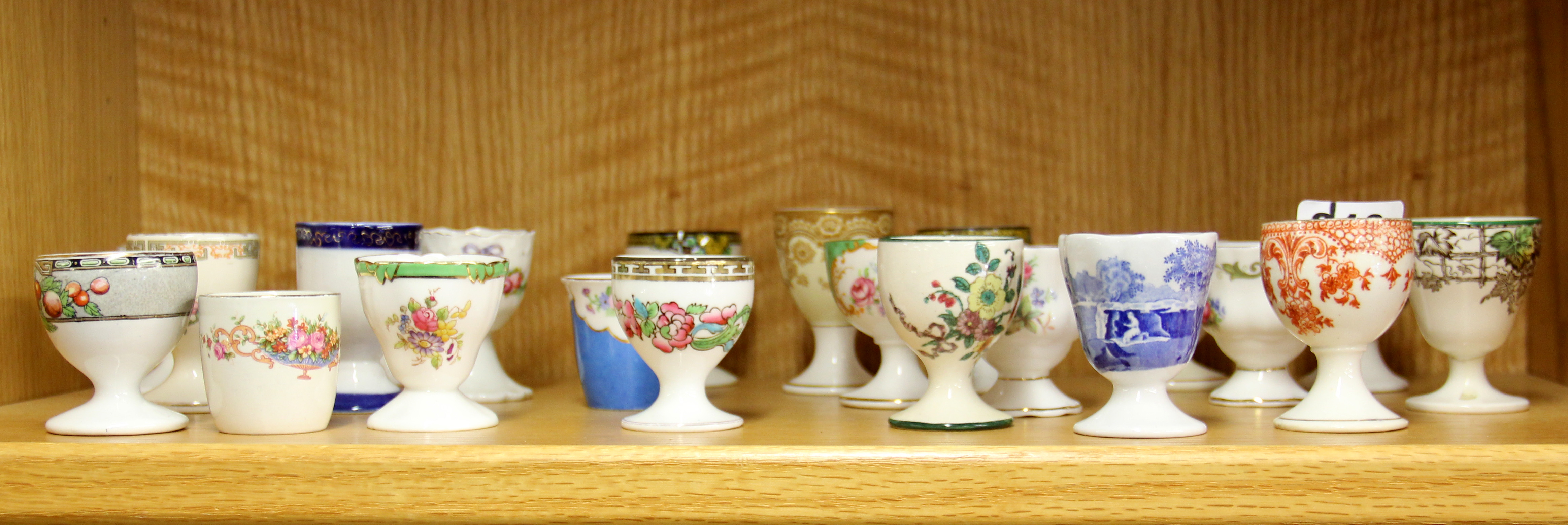 A collection of Spode, Doulton and other egg cups.