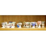 A collection of Spode, Doulton and other egg cups.