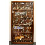 A cabinet of collectors spoons.