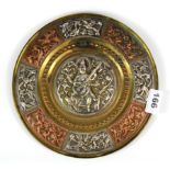 A 19th century Indian silver and copper decorated brass tray, Dia. 23cm.