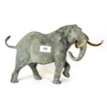 A good quality stone resin figure of an elephant with gilt brass tusks, H. 22cm.