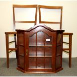 A pair of Edwardian cane seat bedroom chairs and a small glass display cabinet.