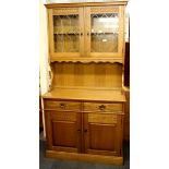 An oak veneered leaded cabinet, W. 94 cm, H. 185cm.