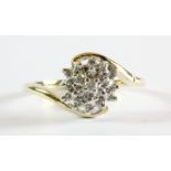 A 9ct yellow gold diamond set cluster ring, (L.5).