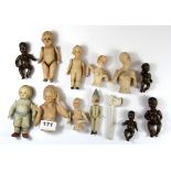 A collection of ceramic dolls and half dolls, together with a single clay pipe.